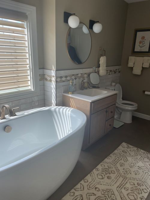 Tile bathroom with standing tub. 